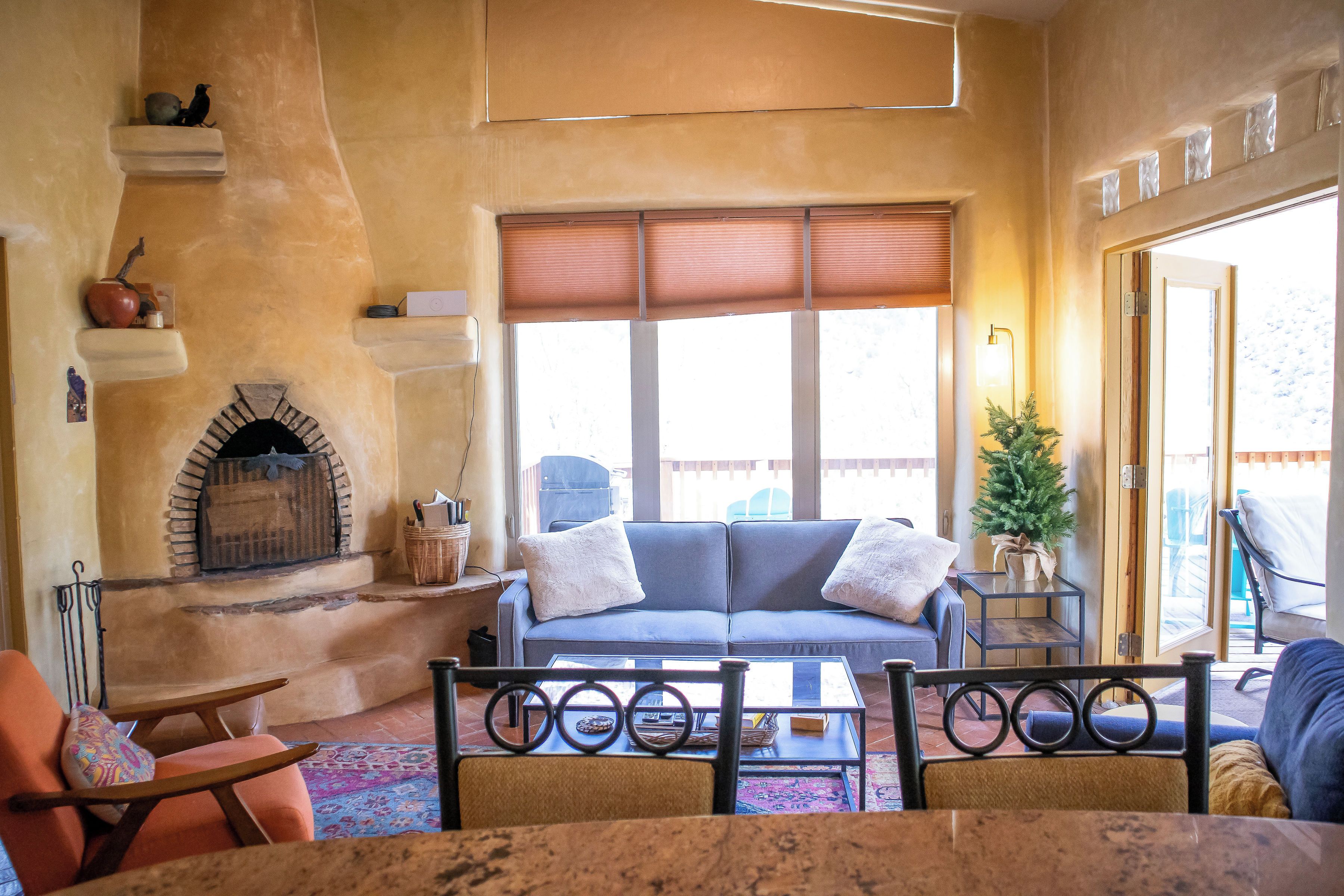 A cozy living room with a fireplace, a sofa, and a coffee table.
