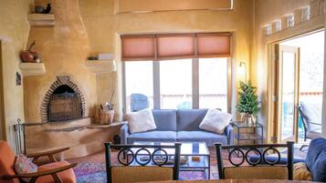 A cozy living room with a fireplace, a sofa, and a coffee table.