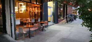 An outdoor café with tables and chairs arranged for seating. - UPER EAST SIDE TRAN STOP AT 96ST OR 103 TWO FROM CENTRAL PARK (Jersey City)