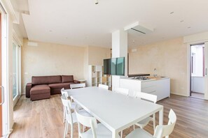 Dining - Luxurious and modern penthouse facing the sea with private solarium on the seafront of Lido di Camaiore with private parking space. The flat is on two levels.The flat opens with the bright living room, where there is a comfortable double sofa bed, dining (Lido di Camaiore)