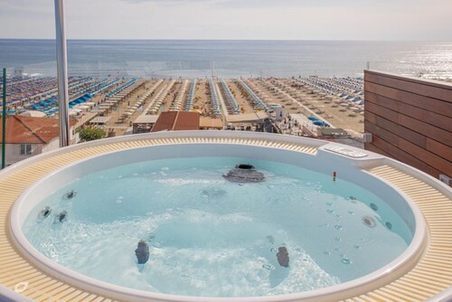 Luxurious and modern penthouse facing the sea with private solarium on the seafront of Lido di Camaiore with private parking space. The flat is on two levels.The flat opens with the bright living room, where there is a comfortable double sofa bed, dining