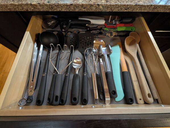 A drawer containing various kitchen utensils including spoons, spatulas, and whisks. - Beautiful Lakeside Log Home near Acadia National Park - kayak, canoe, swim, fish (Ellsworth)