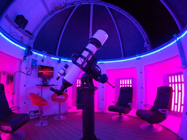 A room with a telescope, swivel chairs, and a dome ceiling. - Observatory, Game Room, Hot tub, Fire Pit, BBQ, 360° View at Observatory Retreat (Yucca Valley)
