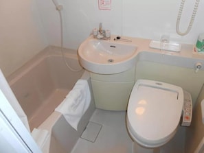 A bathroom with a bathtub, a sink, and a toilet.