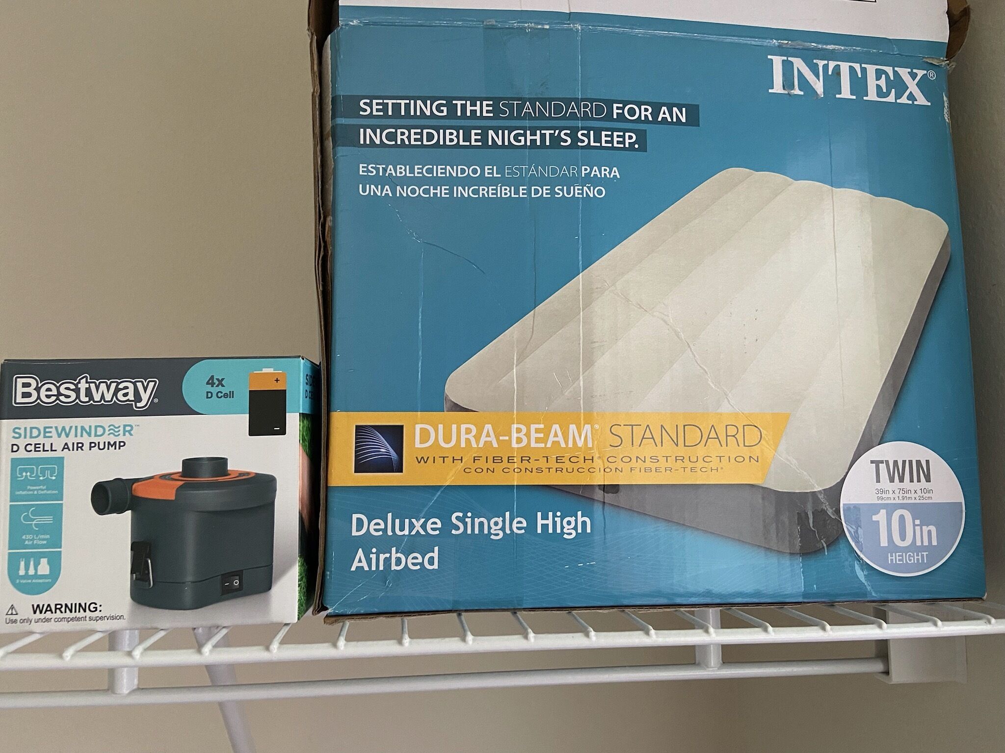 A box of Intex Dura-Beam Standard Deluxe Single High Airbed with a 10-inch twin size.