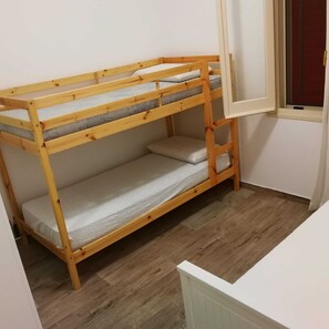 Cozy retreat with a lower and upper bunk bed, perfect for a compact stay.