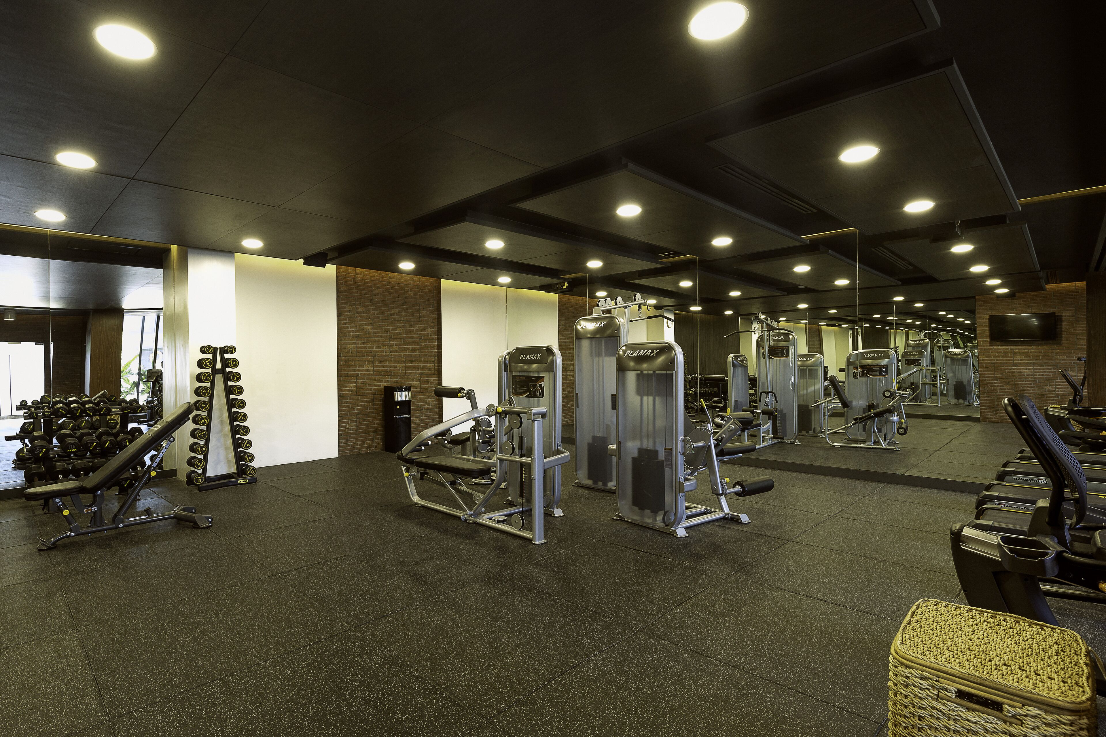 A gym with various exercise equipment, including treadmills and weight machines.
