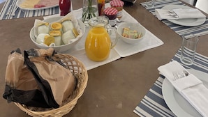 A dining table set with plates, glasses, and a pitcher of orange juice. - Villa Monti: Luxury Villa, Large Pool, Air Con, Amazing Views (Menton)
