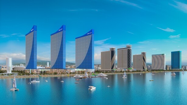 A waterfront cityscape with modern skyscrapers, including three prominent buildings with 'ORBI CITY' signage, and a marina with various boats. - Orbi City Batumi Apartment With sea Views (Batumi)