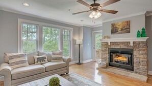 A living room with a fireplace, a sofa, a coffee table, and a ceiling fan. - Timbers P-2- Mtn Condo, Gated Resort, Indoor/Outdoor Pools & Hot Tub, Two Levels (Boone)