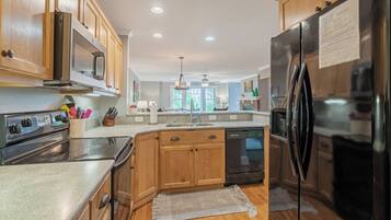 Dishwasher, coffee/tea maker, cookware/dishes/utensils, dining tables