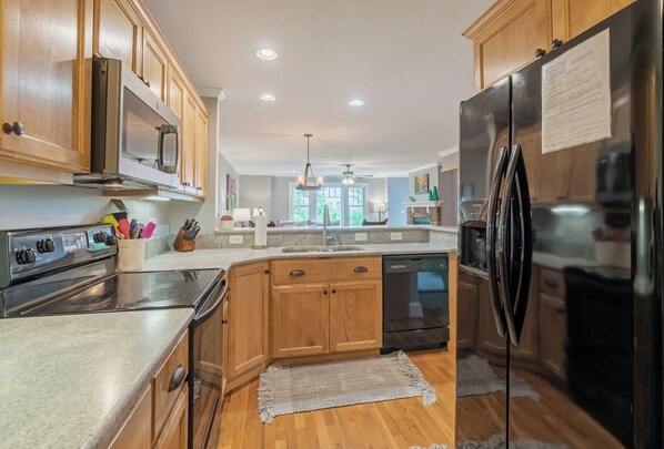 Dishwasher, coffee/tea maker, cookware/dishes/utensils, dining tables