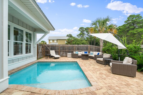 A backyard with a swimming pool, outdoor furniture, and a wooden fence. - Golf Cart ~ Private Pool ~ Near Beach ~ Grill (Santa Rosa Beach)