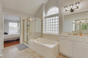 Bathtub, hair dryer, towels, shampoo