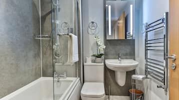 Bathtub, hair dryer, towels, soap