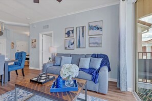 Sunny living room with big 75" smart TV.