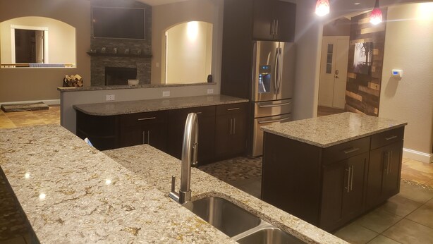 A modern kitchen with granite countertops, stainless steel appliances, and pendant lighting. - 6 Bedroom house on 7 acres (Sheboygan Falls)