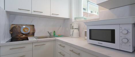 Fridge, coffee/tea maker, toaster, cookware/dishes/utensils