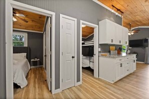 A compact, modern room with a wooden ceiling, a kitchenette, and a bed. - PRIVATE PENINSULA on LAKE NORMAN Pet Friendly! (Denver)
