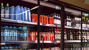 A refrigerated beverage display in a store with various drinks and snacks. - Prize by Radisson, Munich Airport (Hallbergmoos)