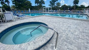 A swimming pool with a no diving sign, lounge chairs, and a spa rules sign. - Come and enjoy NAPLES Florida a slice of paradise (Naples)