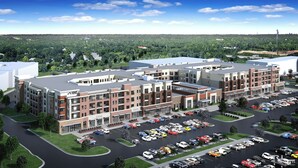 A multi-story commercial building with a parking lot.