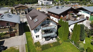 Un quartiere residenziale con case moderne, una seggiovia e uno sfondo montuoso.