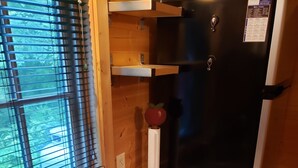 A stainless steel kitchen sink with a soap dispenser, a sponge, and a paper towel holder. - The Tumbleweed Tiny House (Zirconia)