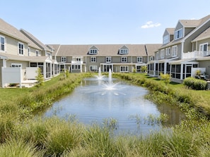 A residential building with a central water feature and a lawn.