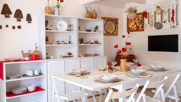 A dining area with white furniture, shelves with decorative items, and a variety of tableware. - Countryside Villa with private pool in Puglia (Monopoli)