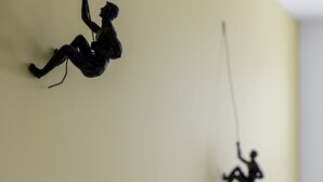 A wall with two black sculptures of figures in dynamic poses. - Luxury 3 bedroom apartment (Boscombe)