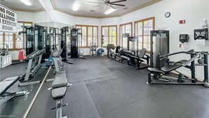 A gym with various exercise equipment, a ceiling fan, and a sign indicating no food allowed. - 10th-Floor Luxury Condo with Stunning Bay &Gulf Views I Walk to Vanderbilt Beach (Naples)