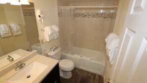 A bathroom with a sink, toilet, and shower area. - The North Lake Lodges & Villas is a quaint boutique resort. Studio and sleeps 2 (Incline Village)