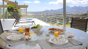 A breakfast table set on a balcony with a scenic mountain view. - La Estrella by Interhome (Altea)