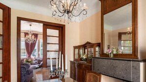 A dining area with a wooden table, lace placemats, and a chandelier. - Beautiful private villa for 6 people with WIFI, TV and terrace (Mol)