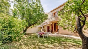 A two-story house with a patio area featuring a table and chairs. - L'ensoleillade by Interhome (Saint Cyr sur mer Les Lecques)