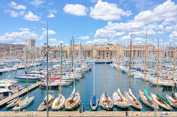 Enjoy waterfront views from this marina with sailboats docked at the piers.
