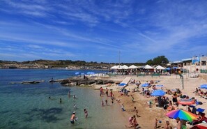 Enjoy a serene beach experience with access to a lively promenade and scenic views.