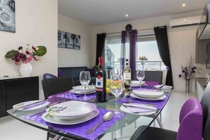 Enjoy meals in this stylish dining area with a glass table, comfortable seating, and a beautiful view.