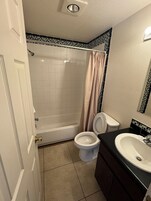 Basic Double Room | Bathroom | Combined shower/tub, rainfall showerhead, towels, soap