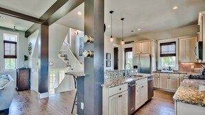 A spacious kitchen with granite countertops, stainless steel appliances, and a large island. - Beach Home with Gulf Views! Steps to Heated Community Pool Minutes to 30A's newest beach access! (Santa Rosa Beach)
