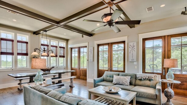 A spacious living room with a high ceiling, large windows, and a ceiling fan. - Beach Home with Gulf Views! Steps to Heated Community Pool Minutes to 30A's newest beach access! (Santa Rosa Beach)