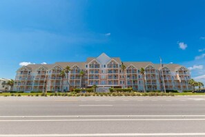 A multi-story hotel with a symmetrical facade, large windows, and a central entrance. - Grand Beach 207 | Pool + Hot Tub + Gulf Views (Gulf Shores)