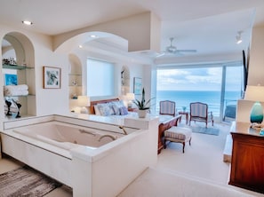 A spacious room with a large bathtub, a seating area with chairs and a sofa, a television, and a view of the ocean. - OCEANFRONT w Amazing Views! Huge CLUB MARENA Rosarito Condo-SAFE Priv Beach/SURF (Rosarito)