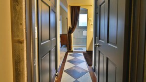 A hallway with a checkered floor leading to a bathroom with a shower and a towel rack. - Ridge Retreat Breckenridge Townhome: Great Location, Views (Breckenridge)