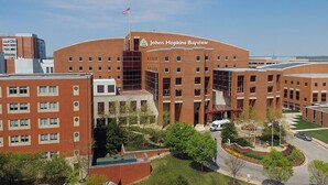 A large brick building with multiple windows and a central entrance.
