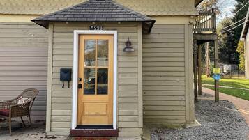 A single-story house with a front door, a mailbox, and a small porch area.