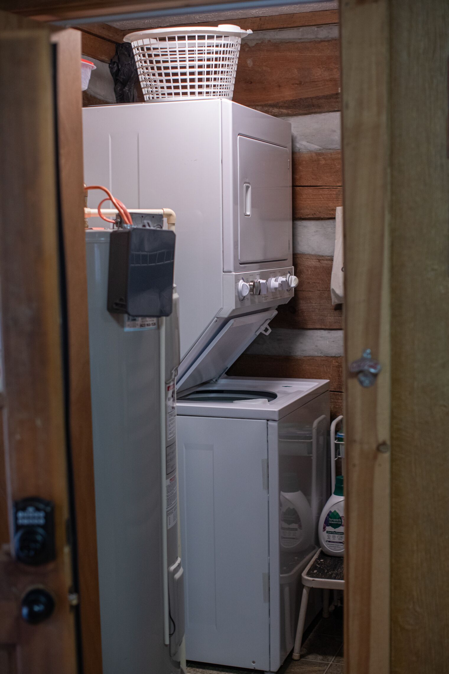 A compact kitchen with a refrigerator, a washing machine, and a small sink.