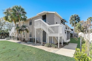 A two-story house with a front porch, a staircase, and a small front yard. - *Charming 2bed 2 bath 6 mins from IMG* (Bradenton)