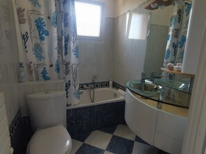 Bathtub, hair dryer, towels, soap